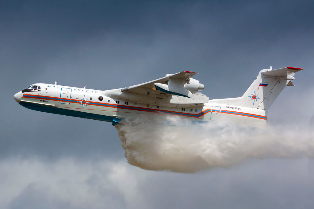 Beriev Be-200 aircraft releasing water during firefighting operation